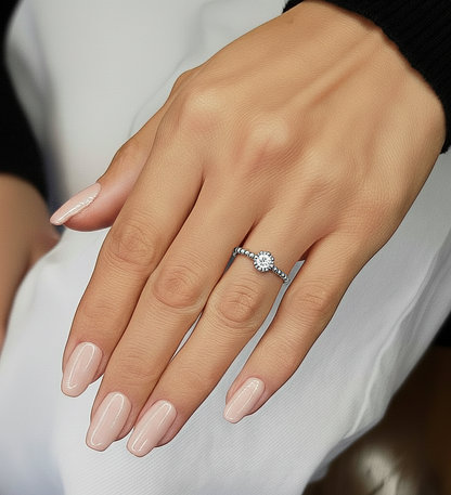 Hand wearing crushed round diamond solitaire engagement ring