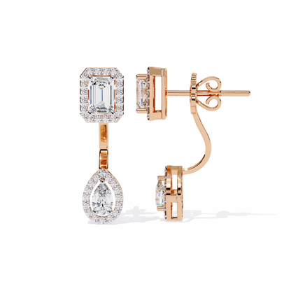 Rose gold emerald cut and pear shape diamond earrings on ear styling look