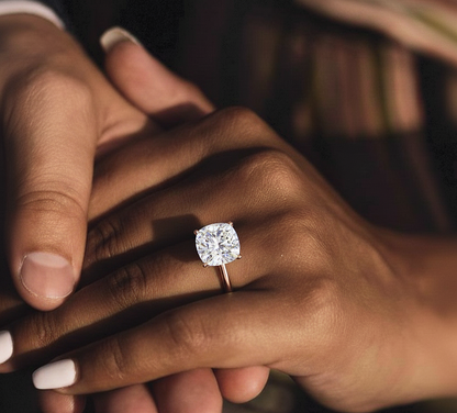 360 view video of cushion cut lab grown diamond prong set solitaire ring rotating on white background