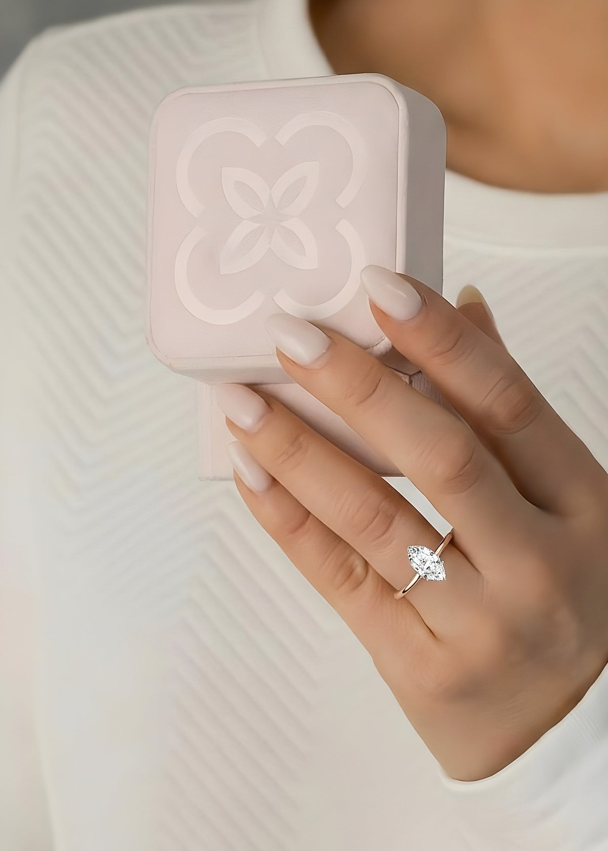 Hand wearing marquise cut lab diamond solitaire ring