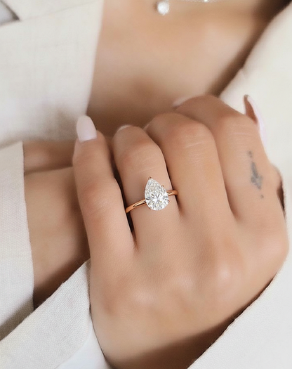 Angled view of pear cut diamond ring with polished finish