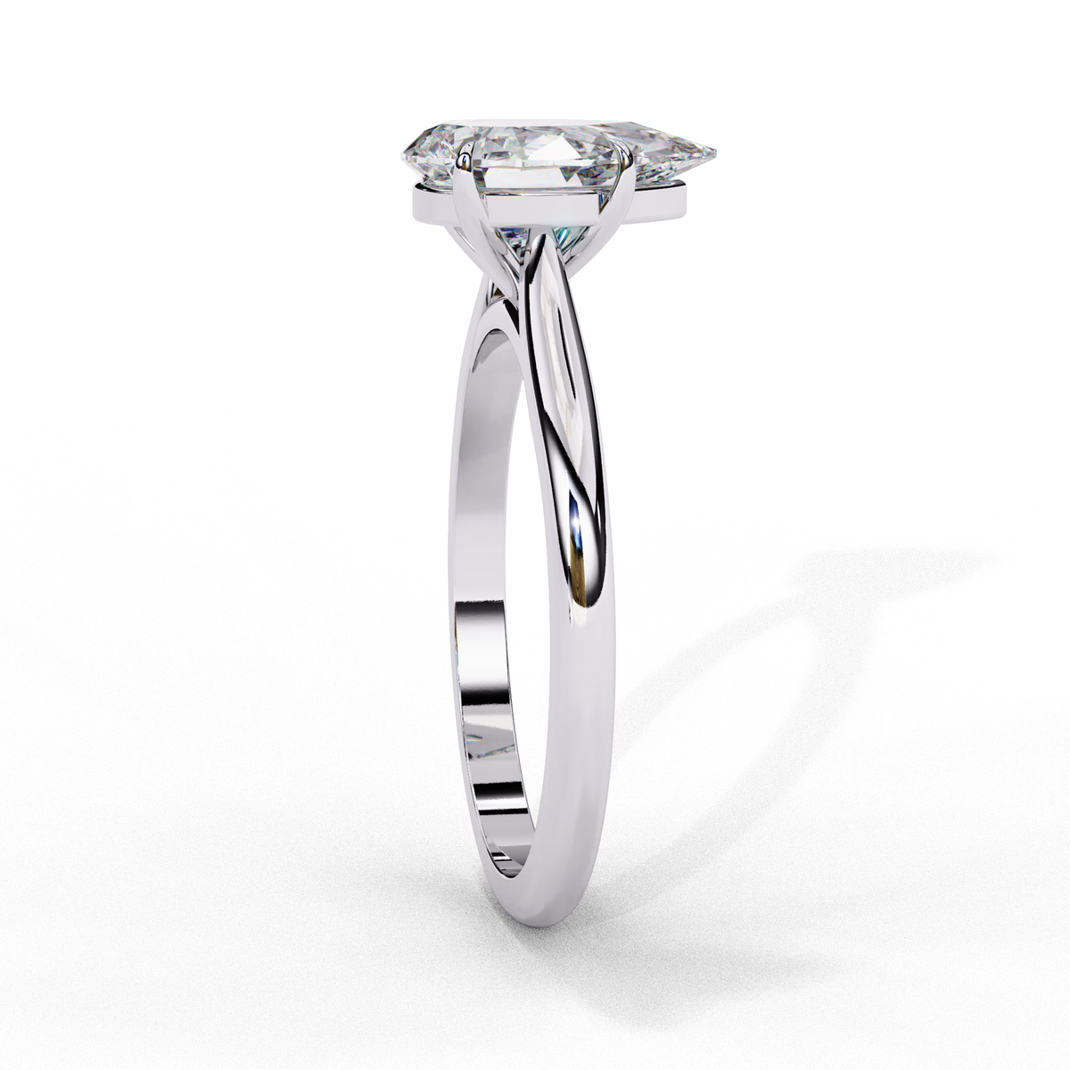 Close up of pear cut solitaire diamond ring with refined prong details