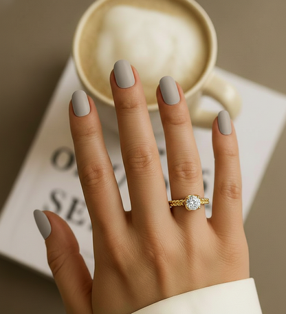 Hand wearing round diamond twisted ring with clean band design