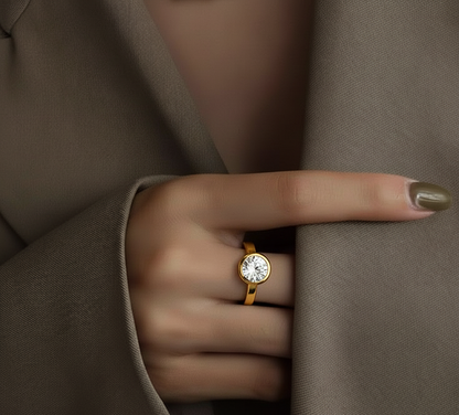 Angled view of round cut diamond ring with polished finish