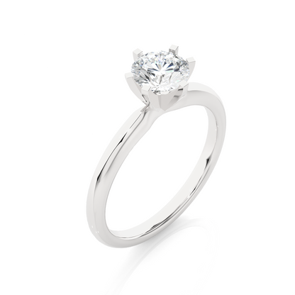 Close up of round cut solitaire ring with refined prong details
