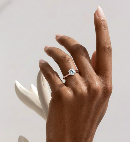 Angled view of round cut diamond ring with polished finish
