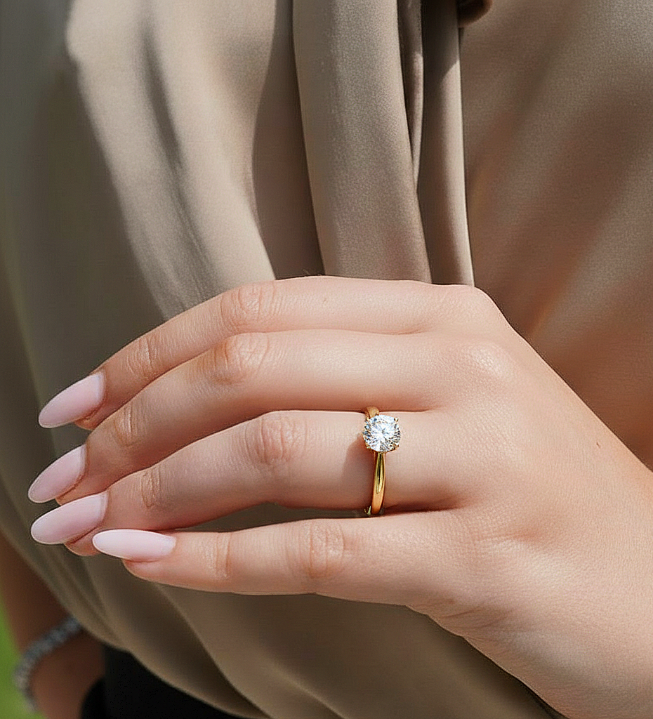 Angled view of round cut solitaire diamond ring with clean finish