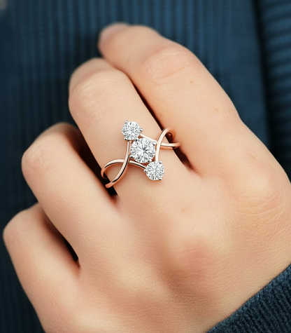 Round three stone lab diamond ring worn on finger with infinity split shank design #wearthelook