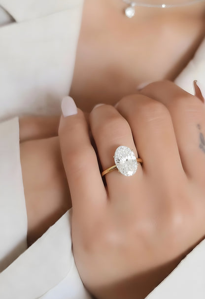 Angled view of oval cut diamond solitaire ring with polished finish