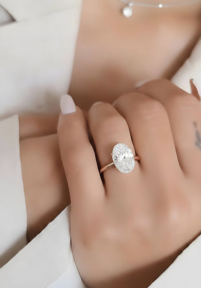 Hand wearing solitaire oval lab grown diamond engagement ring